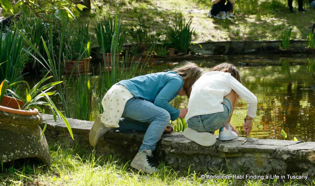 Girls playing with water in a pond 
